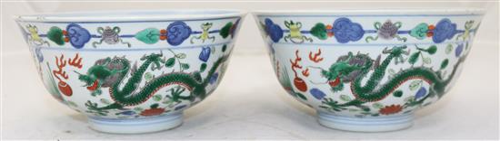 A pair of Chinese wucai dragon and phoenix bowls, Qianlong seal marks, late 19th/early 20th century, 18cm, small rim chips